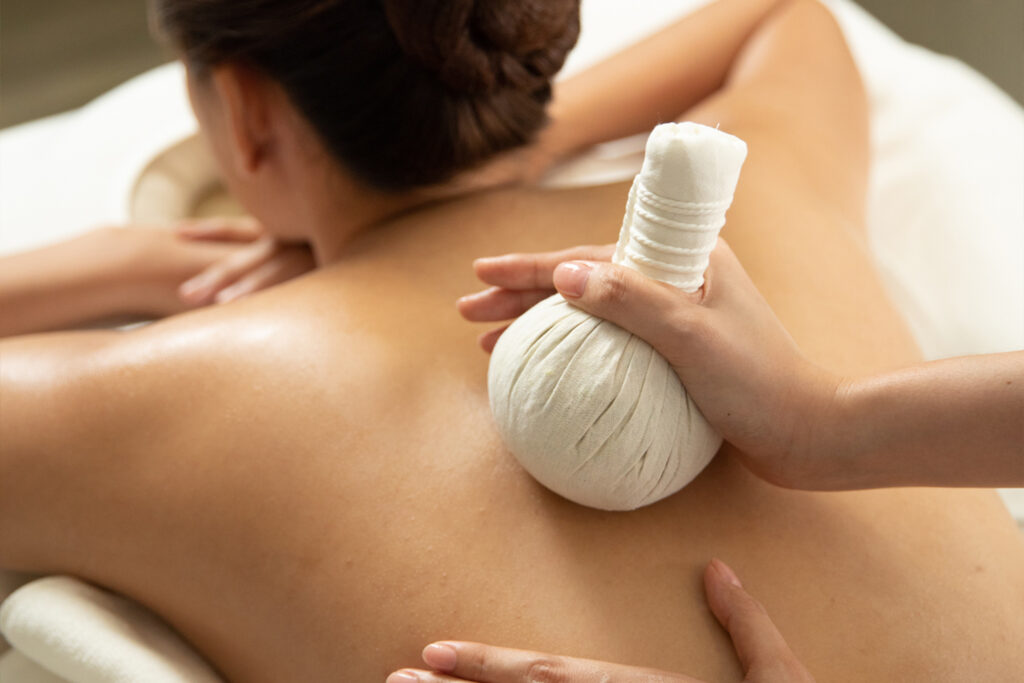 Herbal compress massage Bangkok traditional Thai herbs deep tissue therapy Treasure Spa heated compress