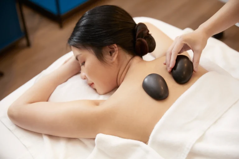 A woman enjoying aromatherapy hot stone massage